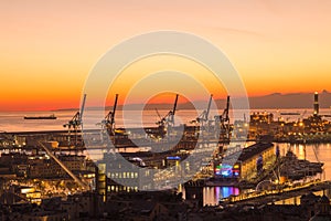 Sunset view of the city of Genoa, Italy. The harbor with Lanterna, the symbol of the city.