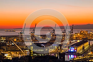 Sunset view of the city of Genoa, Italy, The harbor with Lanterna, the symbol of the city.