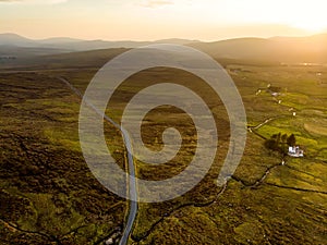 Sunset view of Connemara region in Ireland. Scenic Irish countryside landscape with magnificent mountains on the horizon, County