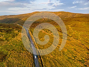 Sunset view of Connemara region in Ireland. Scenic Irish countryside landscape with magnificent mountains on the horizon, County