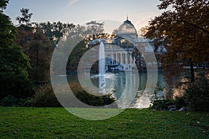 Sunset view of Crystal Palace or Palacio de cristal in Retiro Park in Madrid, Spain.