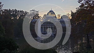 Sunset view of Crystal Palace or Palacio de cristal in Retiro Park in Madrid, Spain.