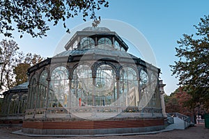 Sunset view of Crystal Palace or Palacio de cristal in Retiro Park in Madrid, Spain.