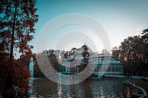 Sunset view of Crystal Palace or Palacio de cristal in Retiro Park in Madrid, Spain.