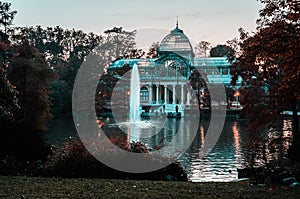 Sunset view of Crystal Palace or Palacio de cristal in Retiro Park in Madrid, Spain.