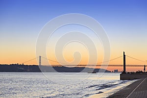 Sunset view of The 25 de Abril Bridge in Lisbon photo