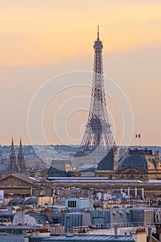 Sunset view of Eiffel Tower with Louvre museum, Notre-Dame cathedral, Parisian rooftops. Famous landmark, icon, travel destination