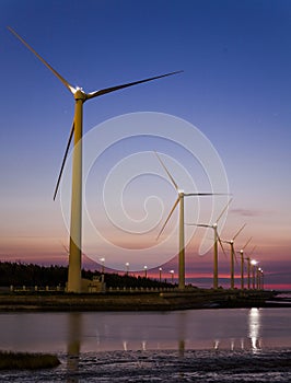 Sunset view of Gaomei wetlands landscape and the wind power plant in Taichung, Taiwan. energy systems and renewable energy.