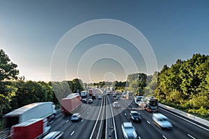 Sunset view heavy traffic moving at speed on UK motorway in England