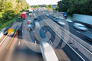 Sunset view heavy traffic moving at speed on UK motorway in England