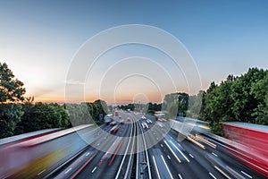 Sunset view heavy traffic moving at speed on UK motorway in England