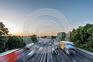 Sunset view heavy traffic moving at speed on UK motorway in England photo