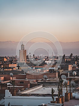 Sunset view of Koutoubia mosque in Marrakesh, Morocco with stork silhouette. Panoramic view of Marrakech with the old