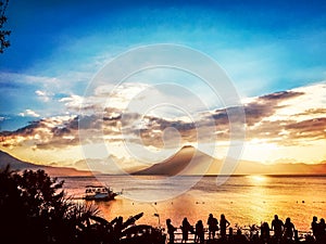 Sunset view of Lake Atitlan & volcano, Guatemala, Central America