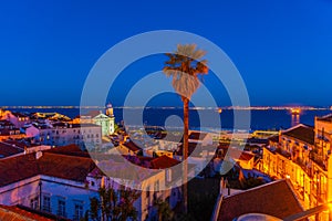 Sunset view of landscape of Alfama district with Sao Estevao church in Lisbon, Portugal