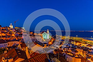 Sunset view of landscape of Alfama district with Sao Estevao church in Lisbon, Portugal
