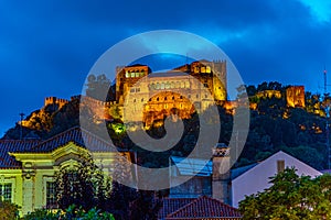 Sunset view of Leiria castle overlooking the old town, Portugal