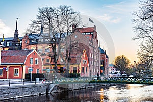 Sunset view of notable buildings alongside river Fyris in Uppsala, Sweden