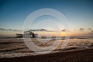Sunset view on old Brighton pier and beach