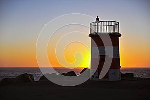 Sunset view of an old lighthouse in Nazare