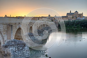 Sunset view of the old roman bridge in the spanish city cordoba