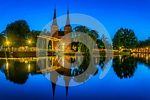 Sunset view of Oostpoort gate leading to the Dutch city Delft, Netherlands