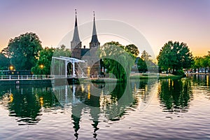 Sunset view of Oostpoort gate leading to the Dutch city Delft, Netherlands