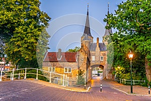 Sunset view of Oostpoort gate leading to the Dutch city Delft, Netherlands