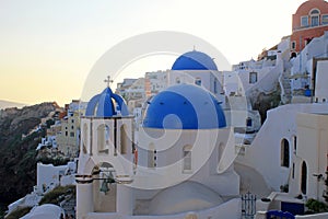 Sunset view with orthodox church,Oia, Santorini island, Greece