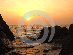 Sunset view over sea with stones