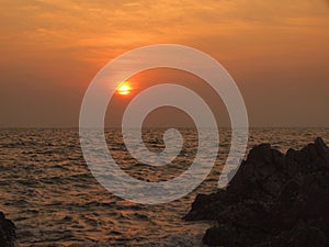 Sunset view over sea with stones