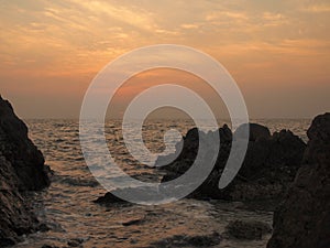 Sunset view over sea with stones