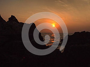 Sunset view over sea with stones