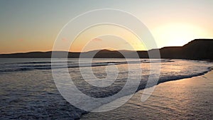 Sunset view of the Pacific Ocean shoreline; Drakes Beach, Point Reyes National Shoreline, California