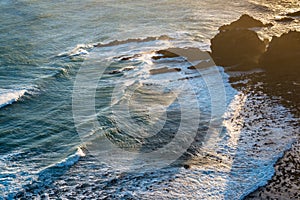 Sunset view of the Pacific Ocean waves at Nugget Point