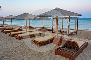 Sunset view of parasols and sunbeds at Vai beach at Crete, Greec