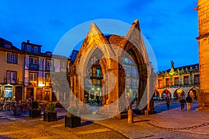 Sunset view of people strolling over Largo da Oliveria in the old town of Guimaraes, Portugal