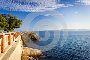 Sunset view of Piazza Bovio with lighthouse in Piombino and Elba Island