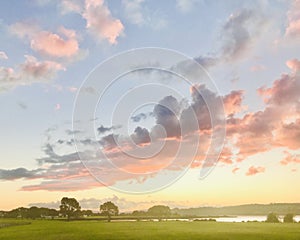 Sunset view with pinky-red clouds and blue sky at the coast.