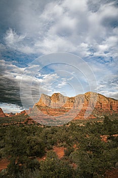 Sunset view of red rock buttes and formations within coconino national forest in Sedona Arizona USA against white cloud background