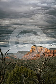 Sunset view of red rock buttes and formations within coconino national forest in Sedona Arizona USA against white cloud background