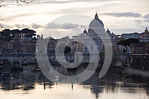 Sunset view on river tiber with St. Peter Basilic in Rome