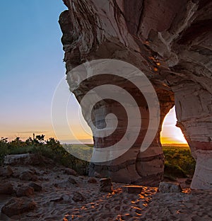 Sunset view through the rock. Arenite eroded by action of wind over time.