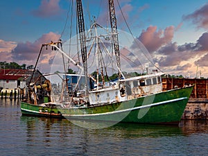 Sunset view of a rusting and abandoned fishing trawler