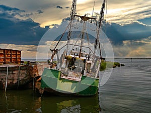 Sunset view of a rusting and abandoned fishing trawler