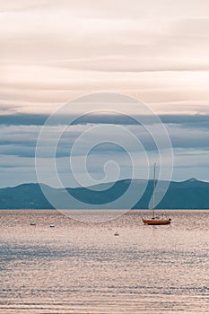 Sunset view of a sailboat and the mountains in Lake Tahoe, Homewood