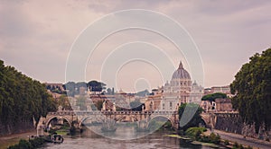 Sunset view of Saint Peter`s Basilica and Sant`Angelo`s Bridge and Tiber river