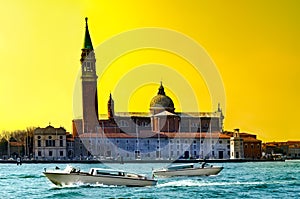 Sunset view of San Giorgio island with boats on Canal Grande, Venice, Italy