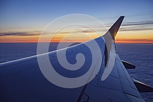 Sunset view of sky from a window seat in an airplane