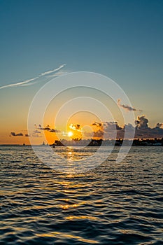 Sunset, view of Sunset y Island from Mallory Square, Key West, Florida, US